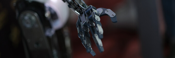 Futuristic black robot arm on black background