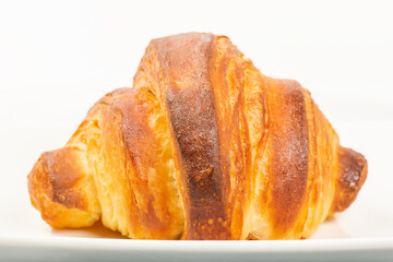 Fresh baked homemade plain butter croissant with a beautiful open honeycomb.