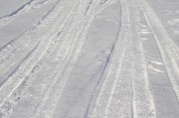 Track from the car on white snow into the distance.