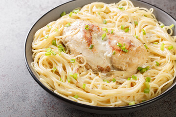 Angel chicken with cream cheese sauce, broth and herbs close-up in a bowl on the table. Horizontal