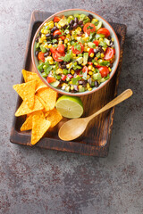 Cowboy caviar or texas caviar salad dip with black bean, tomatoes, avocado, red and green bell...