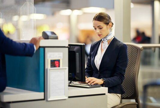 Airport, check in desk and woman typing for security, identity and travel documents for border immigration service. Concierge, customer service and help for global transportation with pc on table - Powered by Adobe