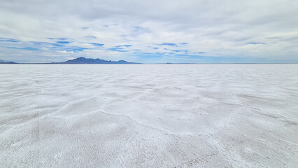 Scenic view of Bonneville Salt Flats in western Utah with Silver Island Mountains peaks in the...