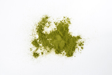 Wheatgrass powder scattered on a white background. Alternative medicine, herbal nutritional supplement