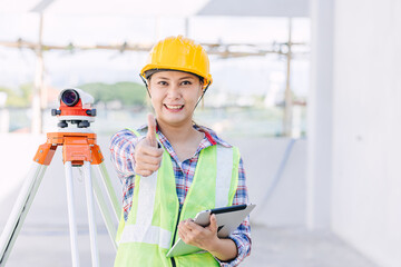 Asian woman engineer worker work in construction site. Smart builder architect female in safety suite working.