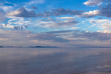 Scenic view of beautiful water reflections in lake of Bonneville Salt Flats at sunset, Wendover, Western Utah, USA, America. Dreamy clouds mirroring on the water surface creating romantic atmosphere