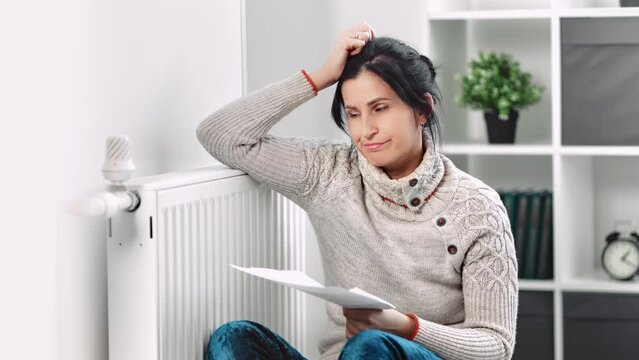 European woman shock worried heating price increase with bill global energetic crisis chores problem