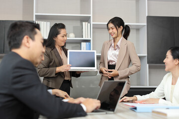 Fototapeta premium Collaborative process of professional businesspeople going over on new project together, using computer presentation and brainstorming ideas, coworker and working together at office meeting concept