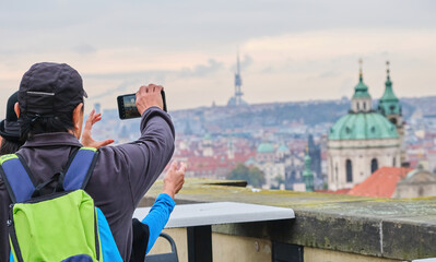 Fototapeta premium traveler tourist make photos taking on holding smartphone trying to take travel photo