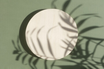 Abstract minimal scene of a geometrical form. A cylindrical wooden podium on a green background...