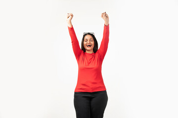 Confident Indian woman rejoicing, looking happy and celebrating victory, fist pump gesture