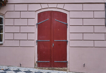 Old Wooden door Heavy duty hinges in ancient medieval design touristic city