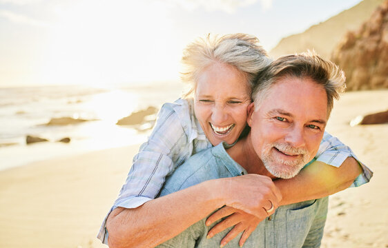 Senior couple, beach and piggyback portrait with smile together, summer and walk for memory, comic time or care. Elderly man, old woman or hug for funny moment, outdoor or sunshine by waves with love