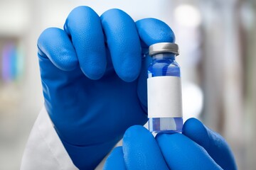 Experimental medical vaccine vial in doctor's hands