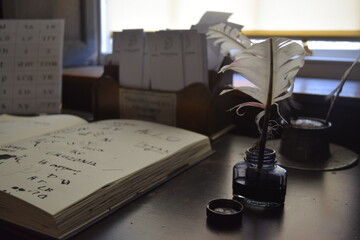 Traditional Writing techniques on paper with Ink pen and feather 