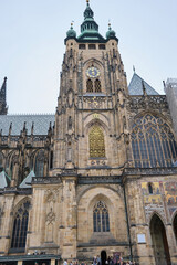Fototapeta na wymiar Side view of St. Vitus cathedral Castle in Prague, Czech Republic clock tower, low angle