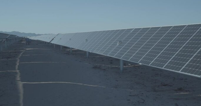 A walk through a solar farm with thousands of solar panels.