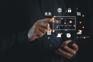 Hand holding credit card and using laptop. Businessman or entrepreneur working from home. Online shopping, e-commerce, internet banking, spending money, work from home concept.
