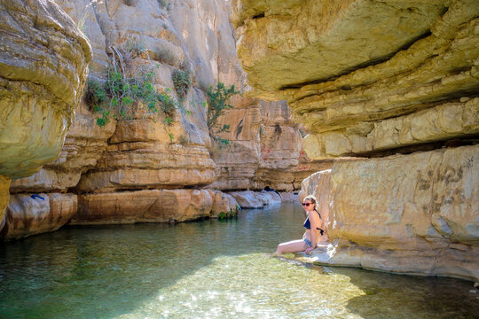 Woman at Ein Quelt spring in Wadi Quelt, Jericho, West Bank, Palestine