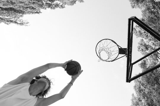 A young basketball player driving to the hoop with some fancy moves.