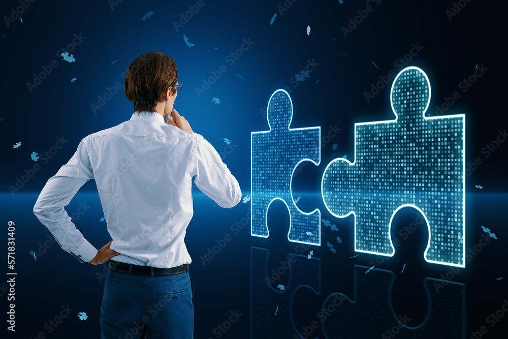 Poster back view of thoughtful young businessman with glowing digital blue jigsaw puzzle hologram on dark b