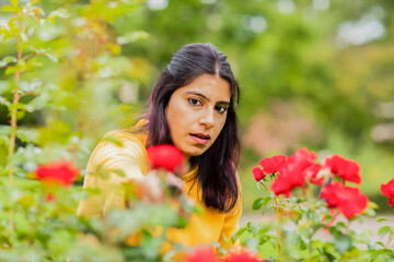 young woman outside cutting roses