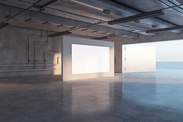 Perspective view on blank white poster with empty place on grey partition in spacious underground hall with water pipes on wall background and glossy concrete floor. 3D rendering, mock up
