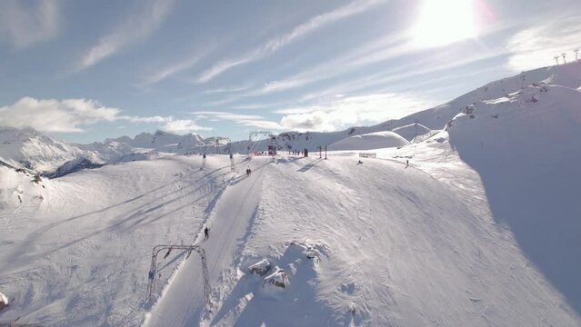 Aerial drone footage of Whistler mountain, BC, ski hill on a sunny day, chairlift, Whistler peak, ski run, skier, winter sport. 5.4K 24FPS