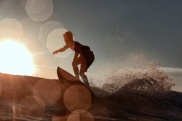 Silhouette of surfer at sunset