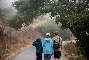 3 young men hiking on foggy trail