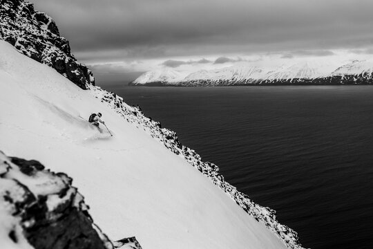 A man backcountry skiing to the ocean at in Iceland.