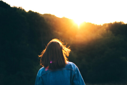 Portrait of a young woman in the sunset in summer