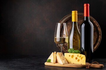 Various cheese on board, red and white wine
