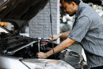 Auto mechanic working in garage. Repair service.
