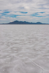 Scenic view of Bonneville Salt Flats in western Utah with Silver Island Mountains peaks in the background, Wendover, USA, America. Densely packed salt pan and natural landscape near Salt Lake City