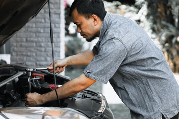 Auto mechanic working in garage. Repair service.
