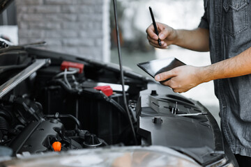 Auto mechanic working in garage. Repair service.
