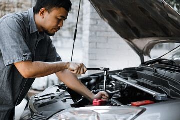 Fototapeta na wymiar Auto mechanic working in garage. Repair service. 