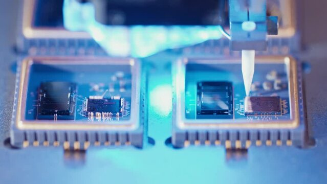 Macro shot of wire bonder connecting wires to a microchip at high speed