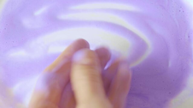 Shampoo or purple mask for the yellowness of blond hair. Air conditioner on female hands.