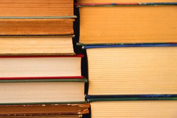 Big pile of books on the table.