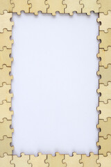 Frame of wooden puzzles with a white background. A puzzle for your ideas. Top view, mock up