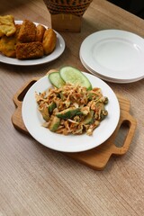 serving of fresh vegetables with spicy peanut sauce on a white plate