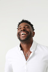 Fototapeta premium Vertical portrait of overjoyed dark skinned man. Good emotions concept. 