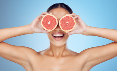 Grapefruit, woman and cover eyes for beauty on studio background, wellness benefits and smile. Skincare model, diet and citrus fruits for natural detox, healthy nutrition and happy face for vitamin c