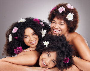 Friends, hair care and portrait of black women with flowers in studio isolated on a gray...