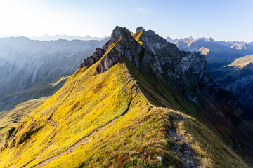 Mountain landscape with colorful autumn alpine meadows and rocky peaks.