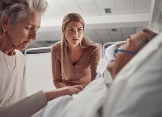Sick, senior and family with a man in hospital for medical support with sad and worried people. Healthcare, ill and woman and daughter with an elderly patient after an accident, injury or dying