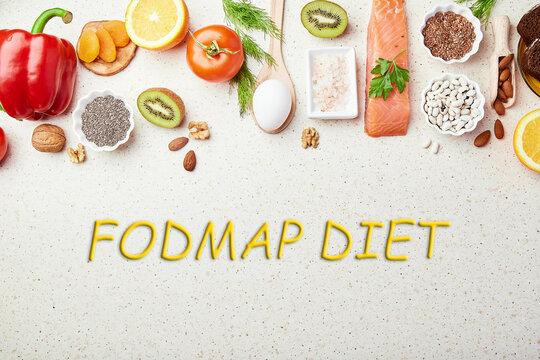 Aesthetics fresh FODMAP Mediterranean diet with text in center. Healthy low fodmap ingredients - vegetables, fruits, nuts, greens, beans, egg, flax seeds, chia seeds. Flat lay