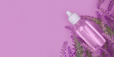 Minimalist mock-up of banner with lavender flowers and lavender oil in transparent bottle